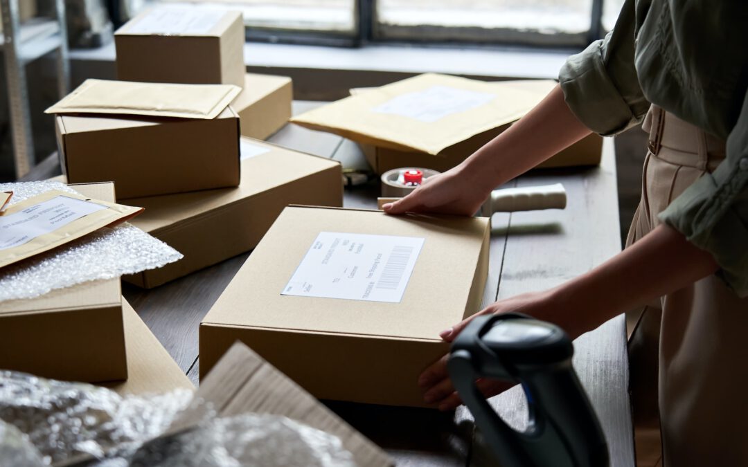 Female seller warehouse worker packing shipping order box for dispatching.