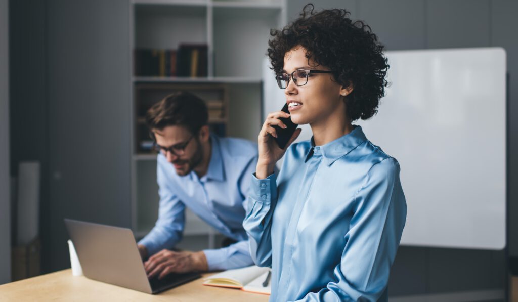 Millenial business man and woman working in office