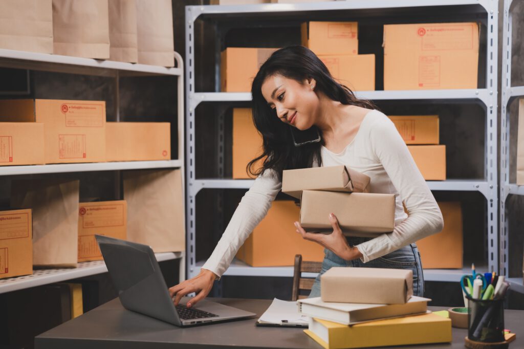 woman entrepreneur's hand holding package of parcel box, Preparing pack delivery packet product