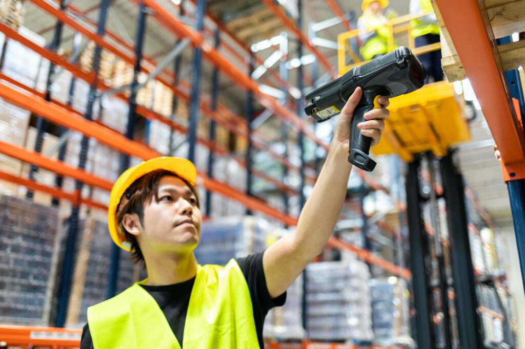 Workers in warehouse scanning packages