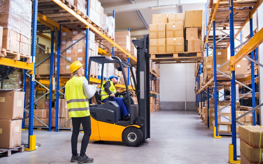 Young warehouse workers working together.